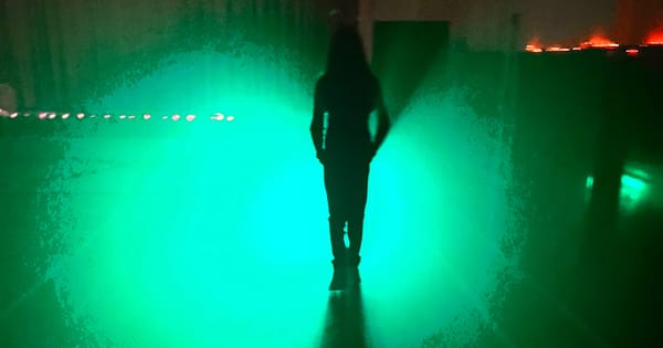 shadowy figure with spooky green light blooming masking the location